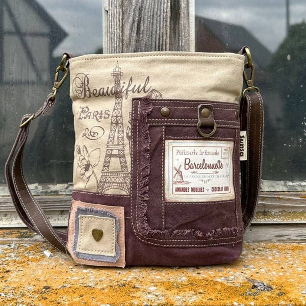 Sunsa -schoudertas, gemaakt van canvas en leer. Medium -grootte handtas met opdruk in Parijs.