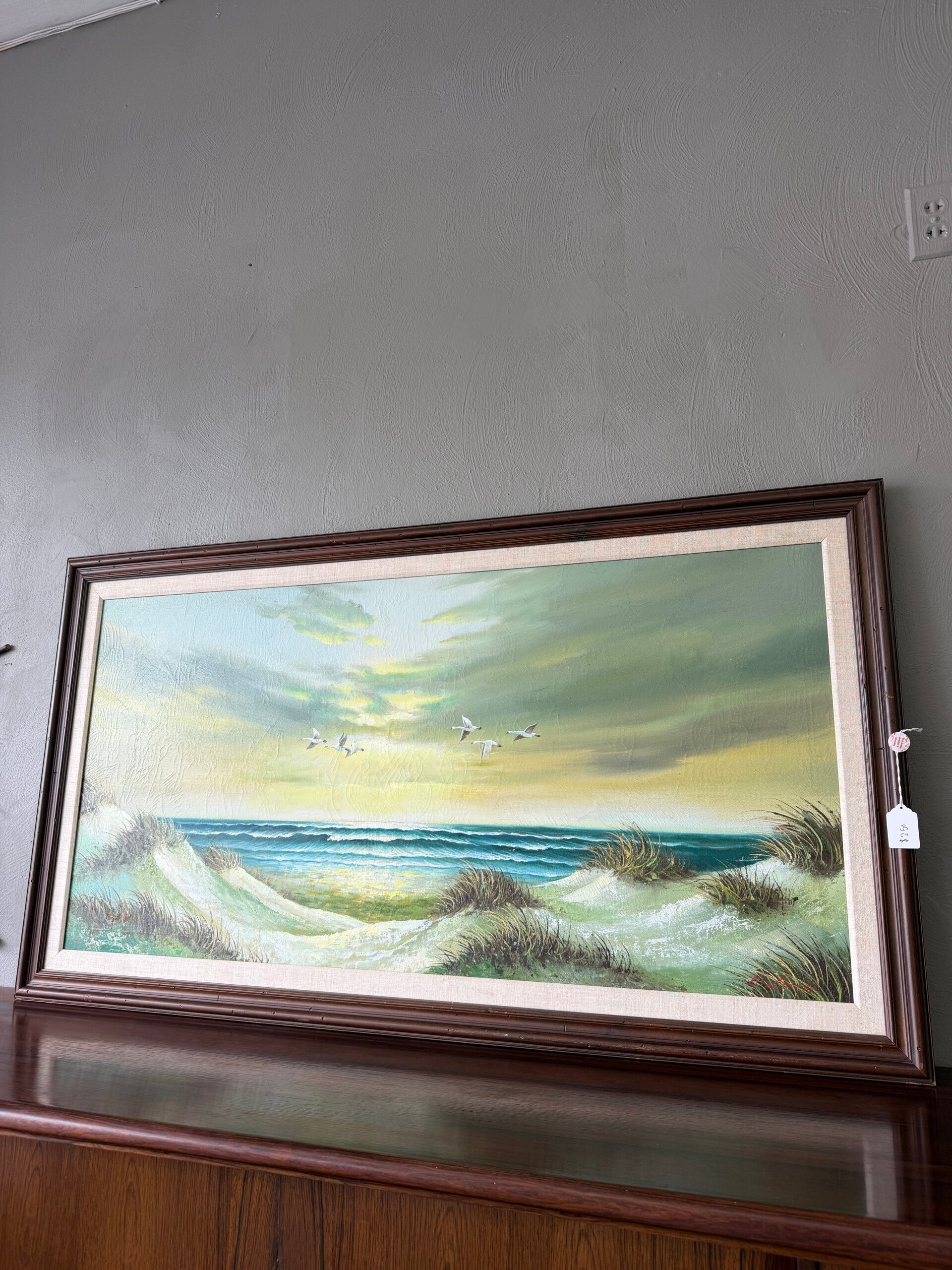 framed original painting featuring a seascape scene with dunes and seagulls