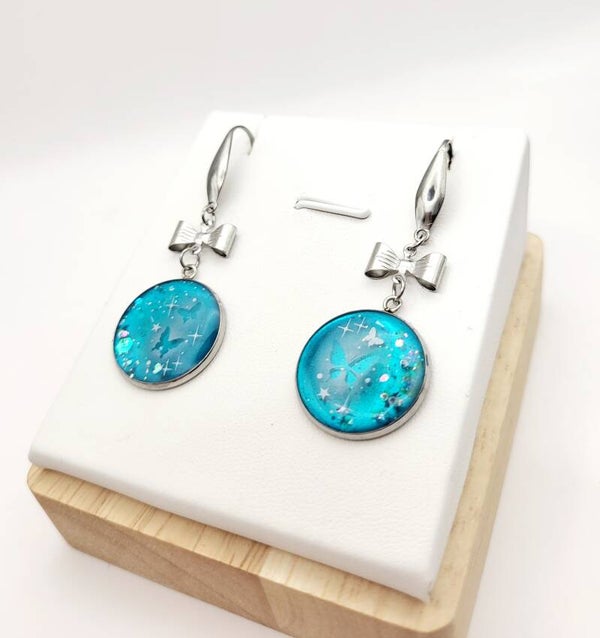 Boucles " Petits nœuds turquoises en transparence"