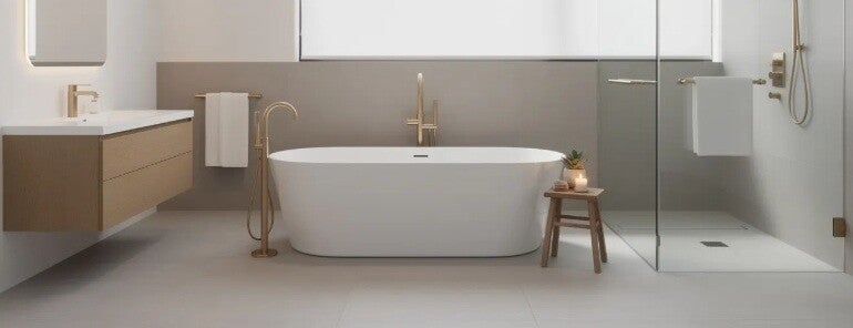 The image features a modern bathroom showcasing a newly installed freestanding bath surrounded by elegant fixtures and stylish vanities. This luxurious space highlights high-quality renovations with premium materials, creating a dream bathroom that exempl