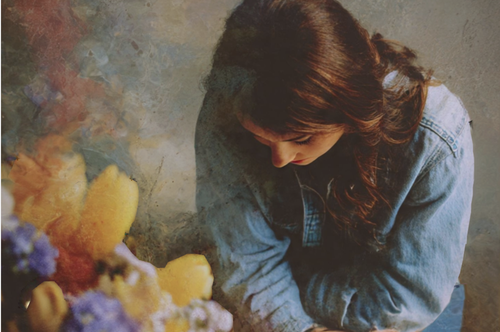 Two large white cruise ships docked at a tropical port with palm trees in the foreground and a clear blue sky.