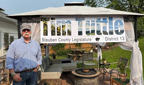 Tim Tuttle and Large Campaign Sign at Home