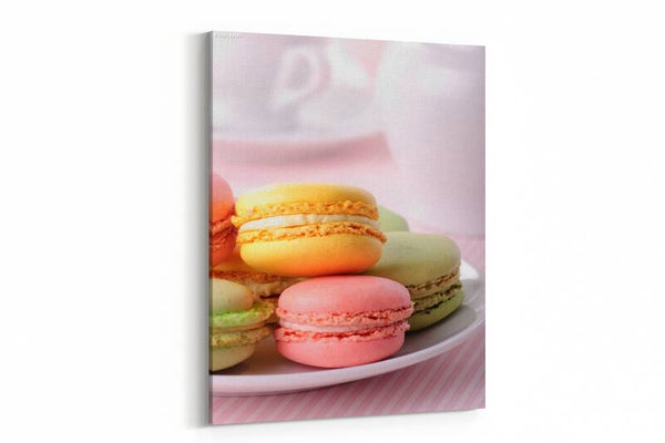Pink, yellow, green macaroones on white plate