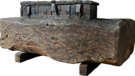 Ancient church chest embedded in a huge tree trunk dating from early 1600's