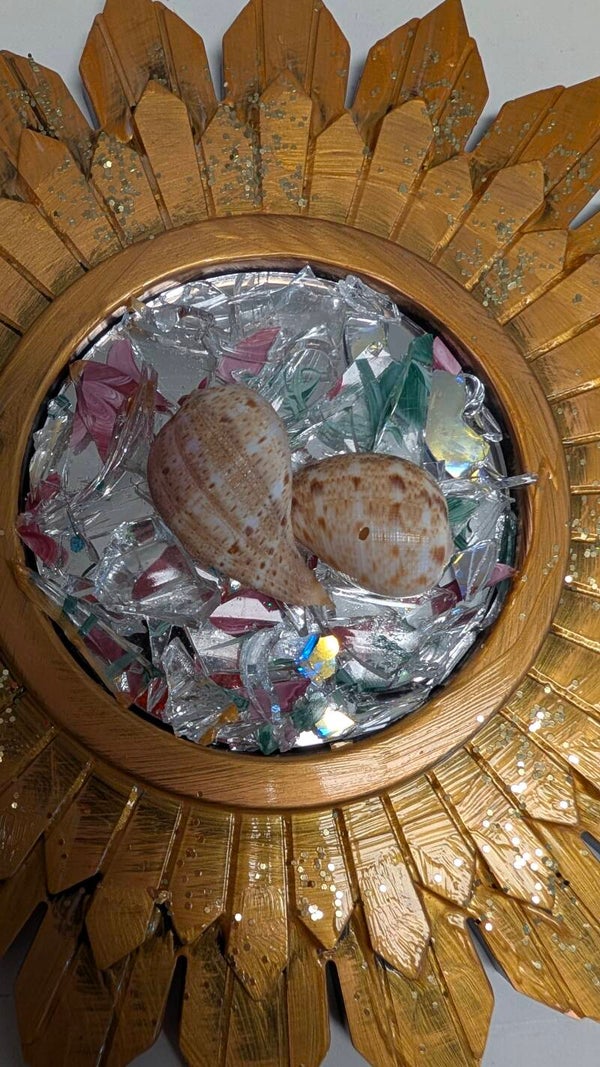 ocean sunOne of a kind piece ocean themed 9x9round plastic frame with crushed glass and seashells. it is mesmerizing to look at when the Sun hits it and the light beautiful in any room