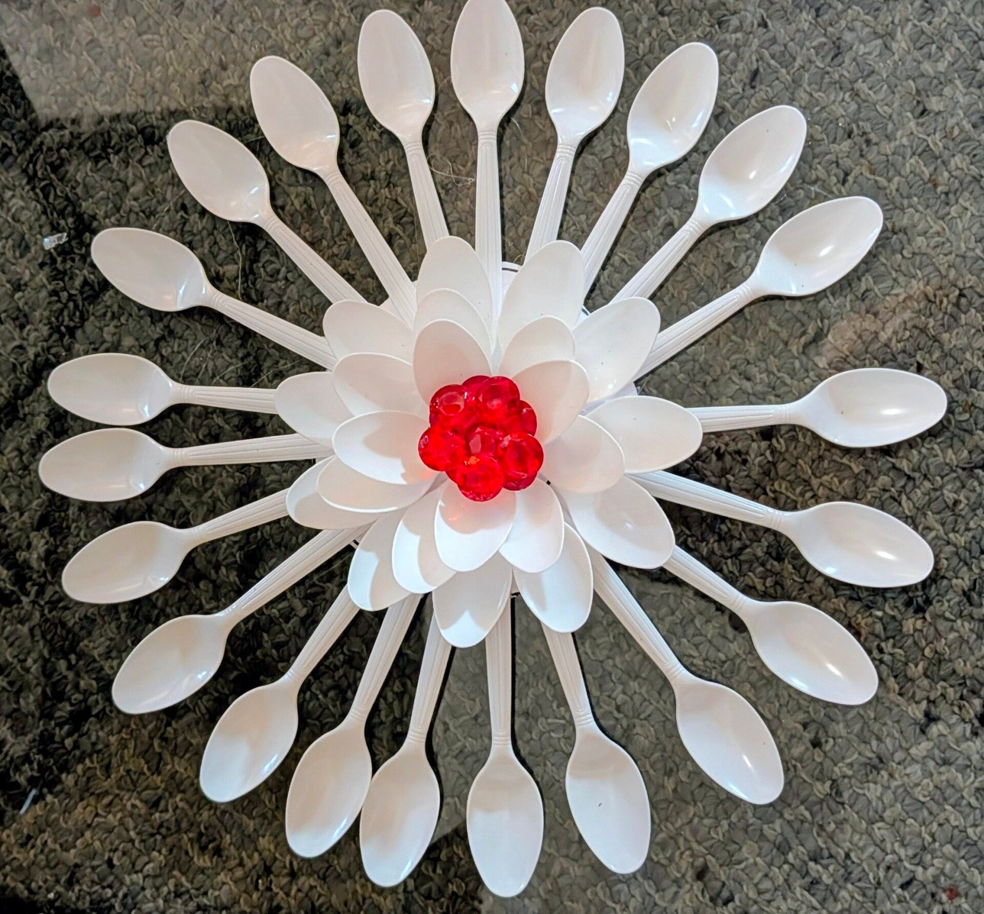 spoons one of a kind Turn ordinary white plastic spoons into a stunning, budget-friendly floral wall piece. With just a little hot glue, a few layers of spoon heads, and a pop of color in the center, you can create a gorgeous dahlia-inspired decor item th