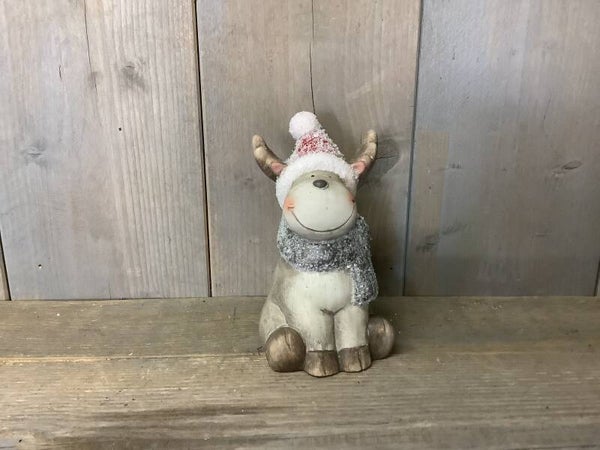 Stenen rendieren met kerstmuts