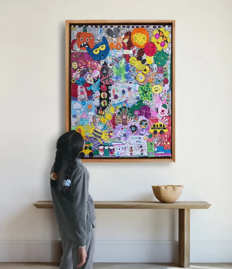 Child admiring a framed collage created from children’s original artwork