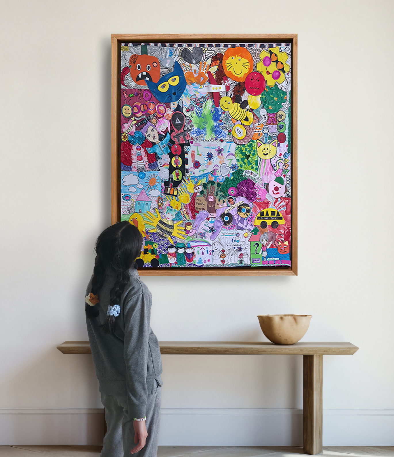 Young child artist admiring a large framed custom gallery collage of their own drawings on a home wall."