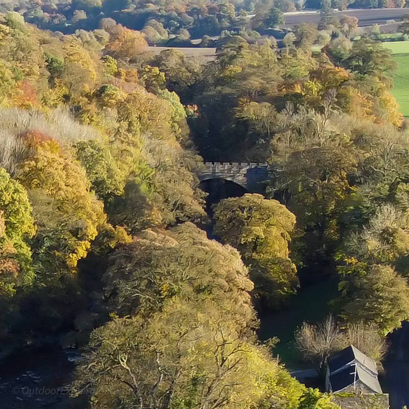 Aerial view of Abbey Bridge crossing the wooded River Tees valley near Egglestone Abbey in Teesdale.