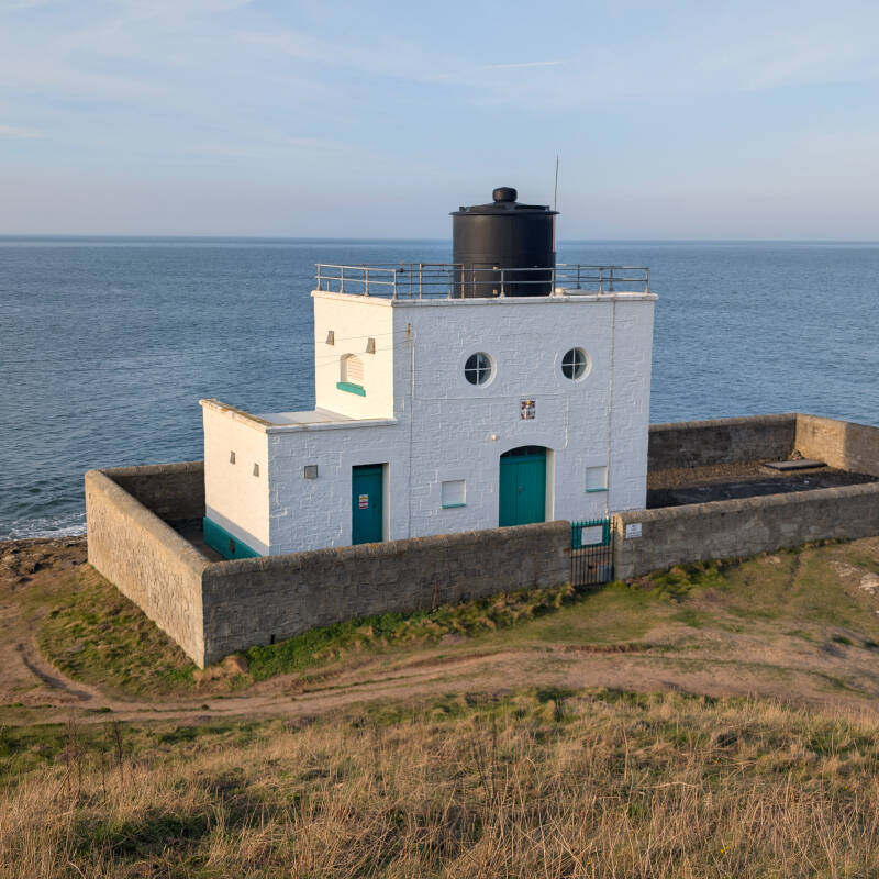 Bamburgh Lighthouse at Harkness Rocks overlooking the North Sea