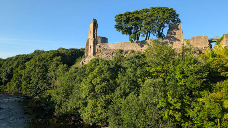 Barnard Castle standing above the wooded River Tees, viewed from the Startforth side of the river.