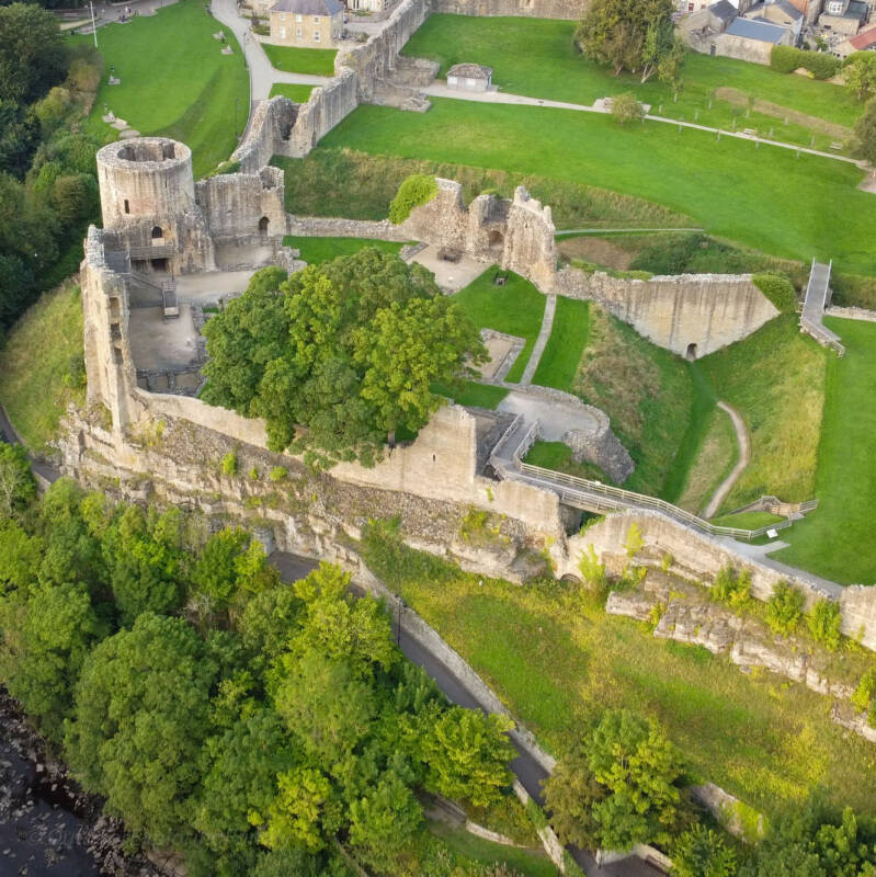 Wide aerial view of Barnard Castle showing the Round Tower, Inner Ward, outer wards and the grounds beside Scar Top.
