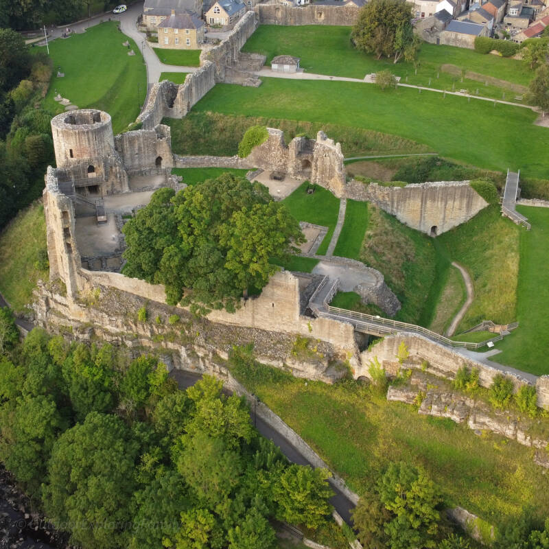 Barnard Castle ruins from above showing stone walls and green grounds overlooking the River Tees