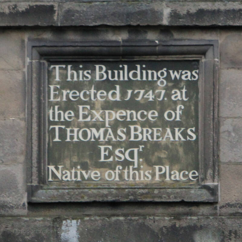 Inscription plaque on Barnard Castle Market Cross showing it was erected in 1747 at the expense of Thomas Breaks.
