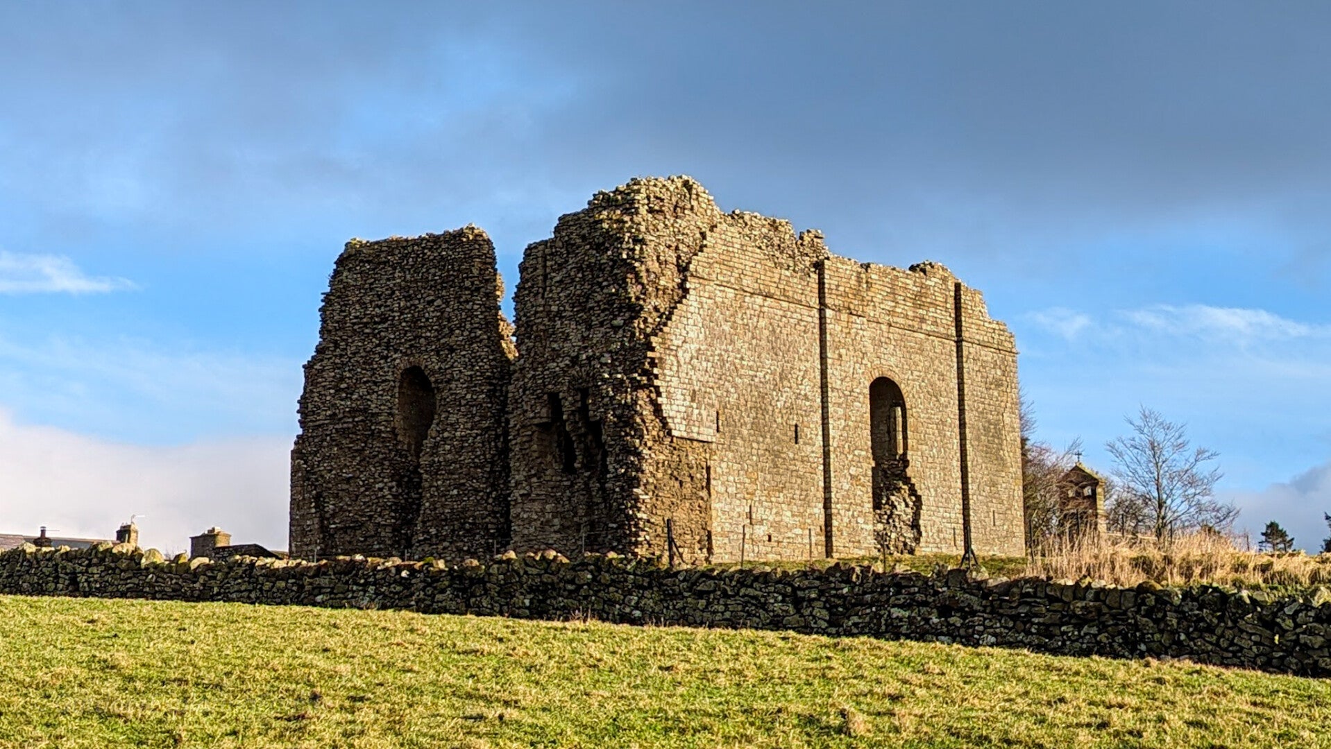 Bowes Castle keep in County Durham standing above Bowes village on a bright winter morning