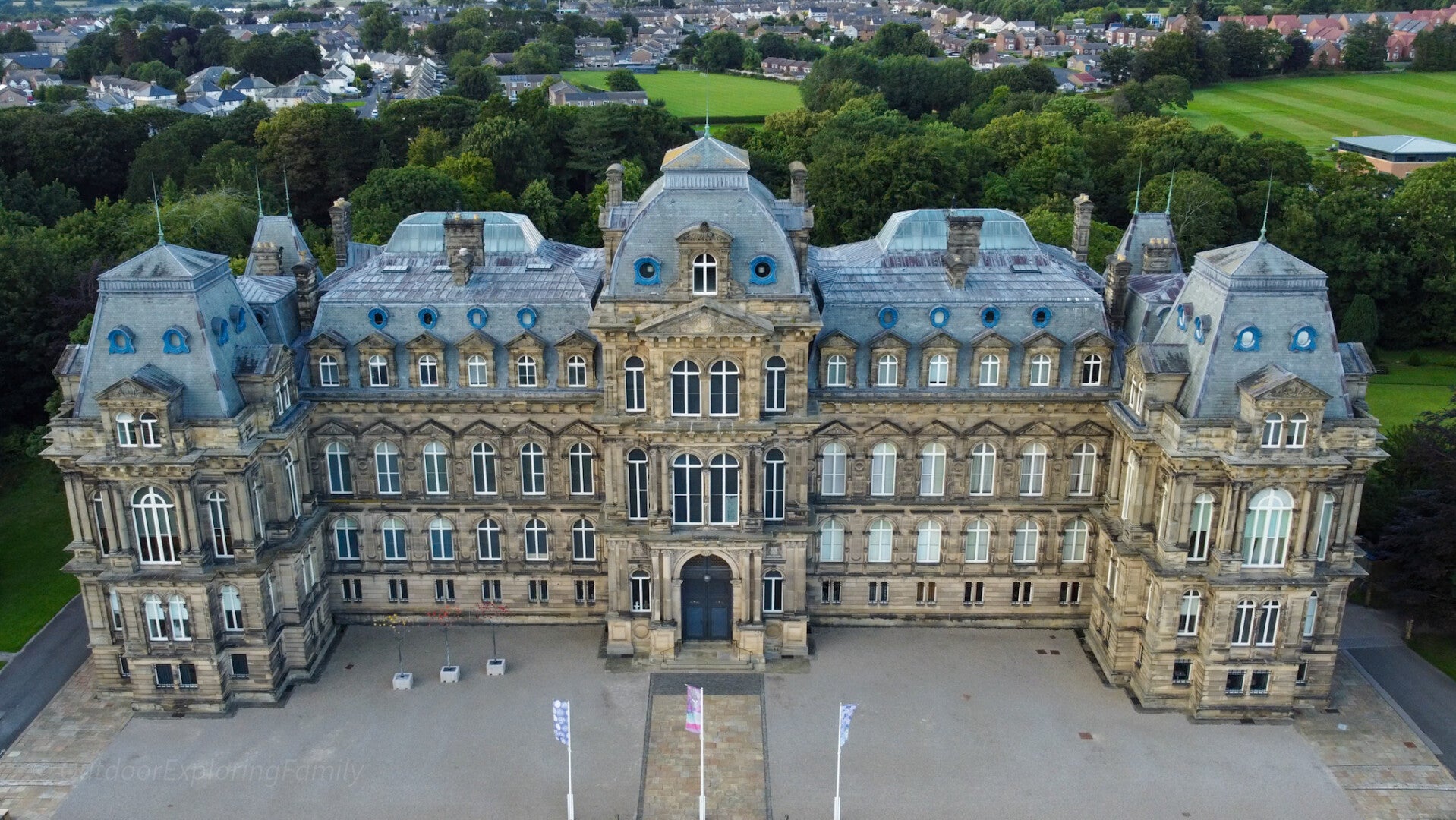 Aerial view of The Bowes Museum in Barnard Castle showing the grand French style architecture and surrounding parkland in Teesdale.