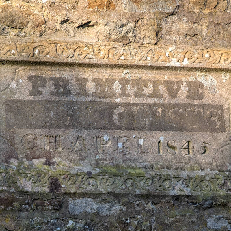 Carved stone with 1845 date on rear wall of Bowlees chapel in Teesdale