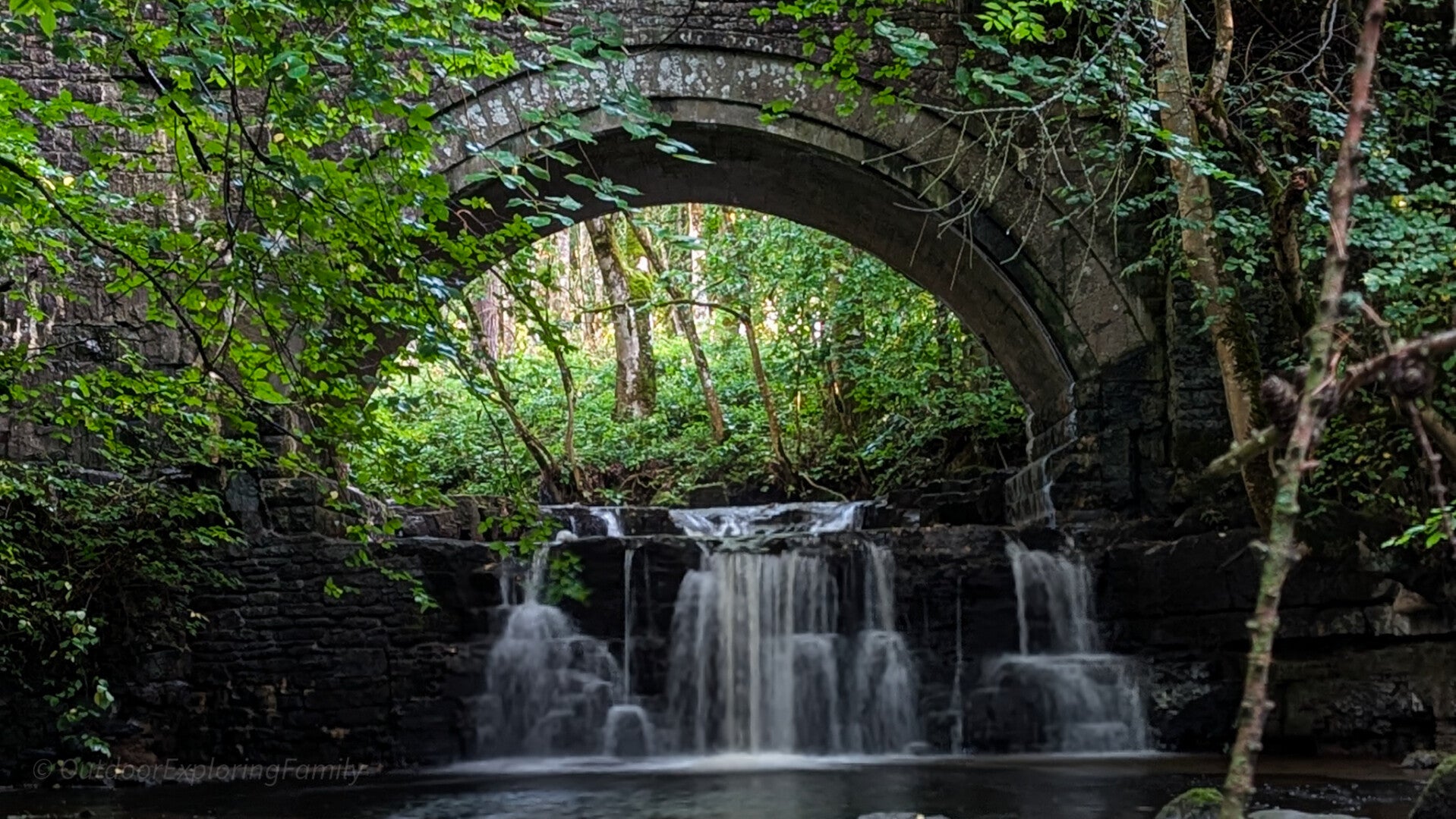 Hidden waterfall on Bow Beck beneath Bow Lee Bridge at Bowlees Visitor Centre in Teesdale
