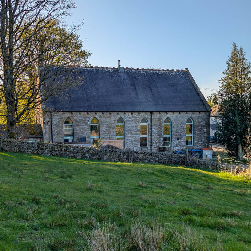 Side view of Bowlees Visitor Centre with arched windows and stone walls in Teesdale