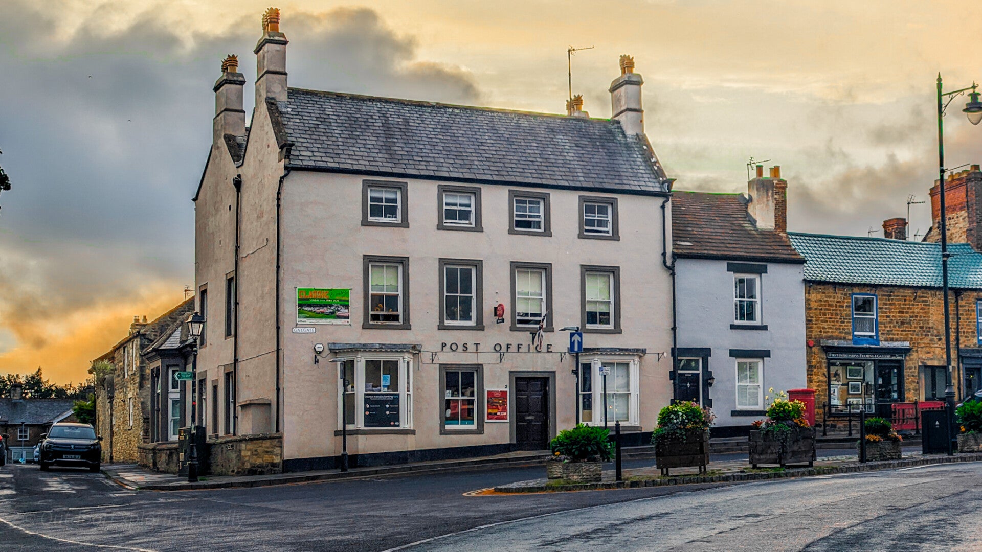 Wider view of Brampton House, now Barnard Castle Post Office, with neighbouring buildings and Galgate in the foreground.