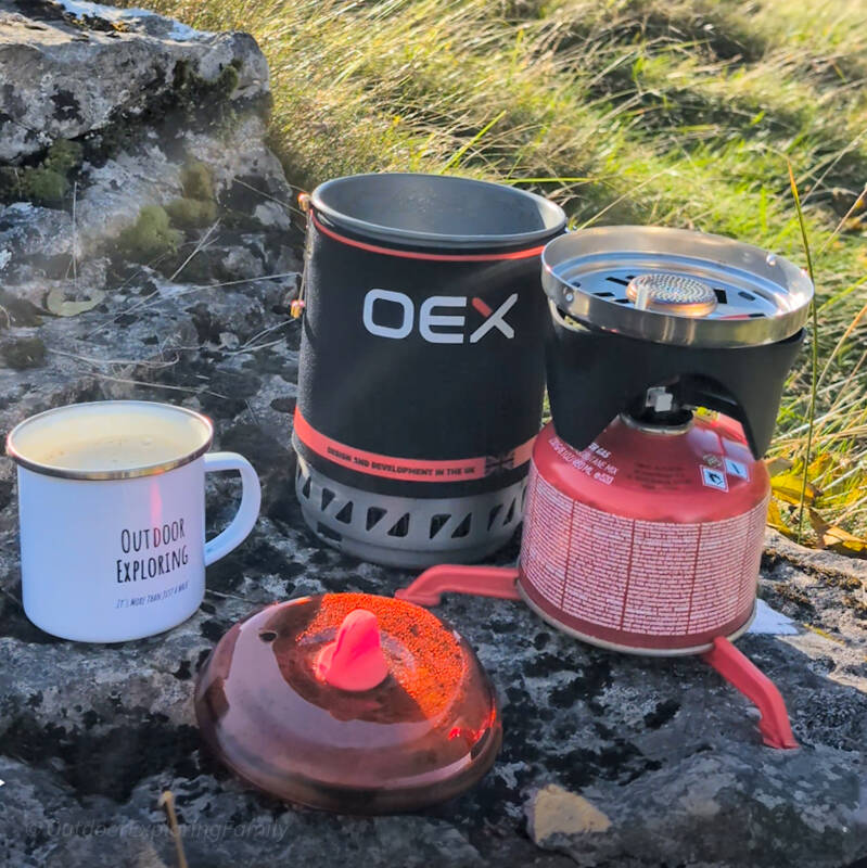 Lightweight OEX camping stove set up on rock ready for boiling water outdoors