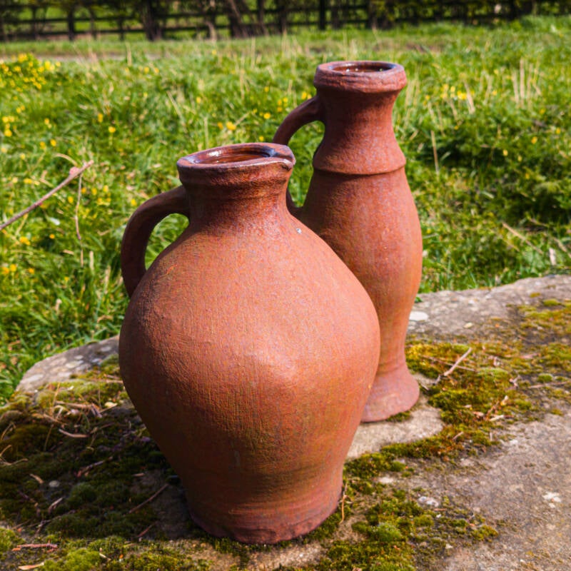 Cast iron water jugs beside a bench overlooking Egglestone Abbey in Teesdale