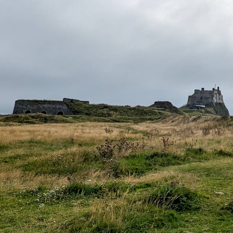 Victorian Castle Point lime kilns on Holy Island with Lindisfarne Castle visible behind