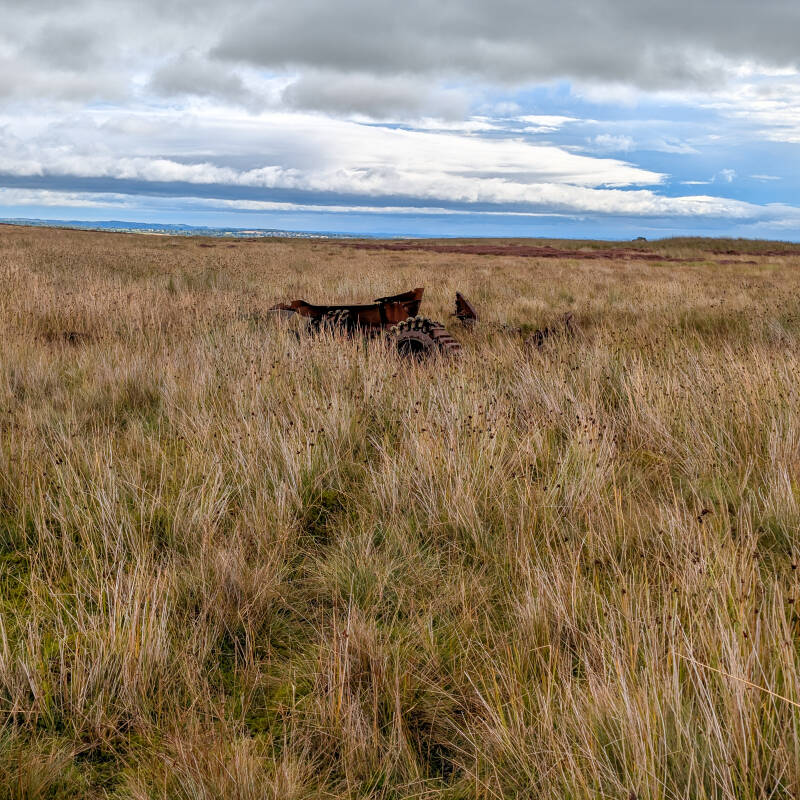 Cotherstone Moor tank wreck partly hidden in rough grass and heather on the open moor