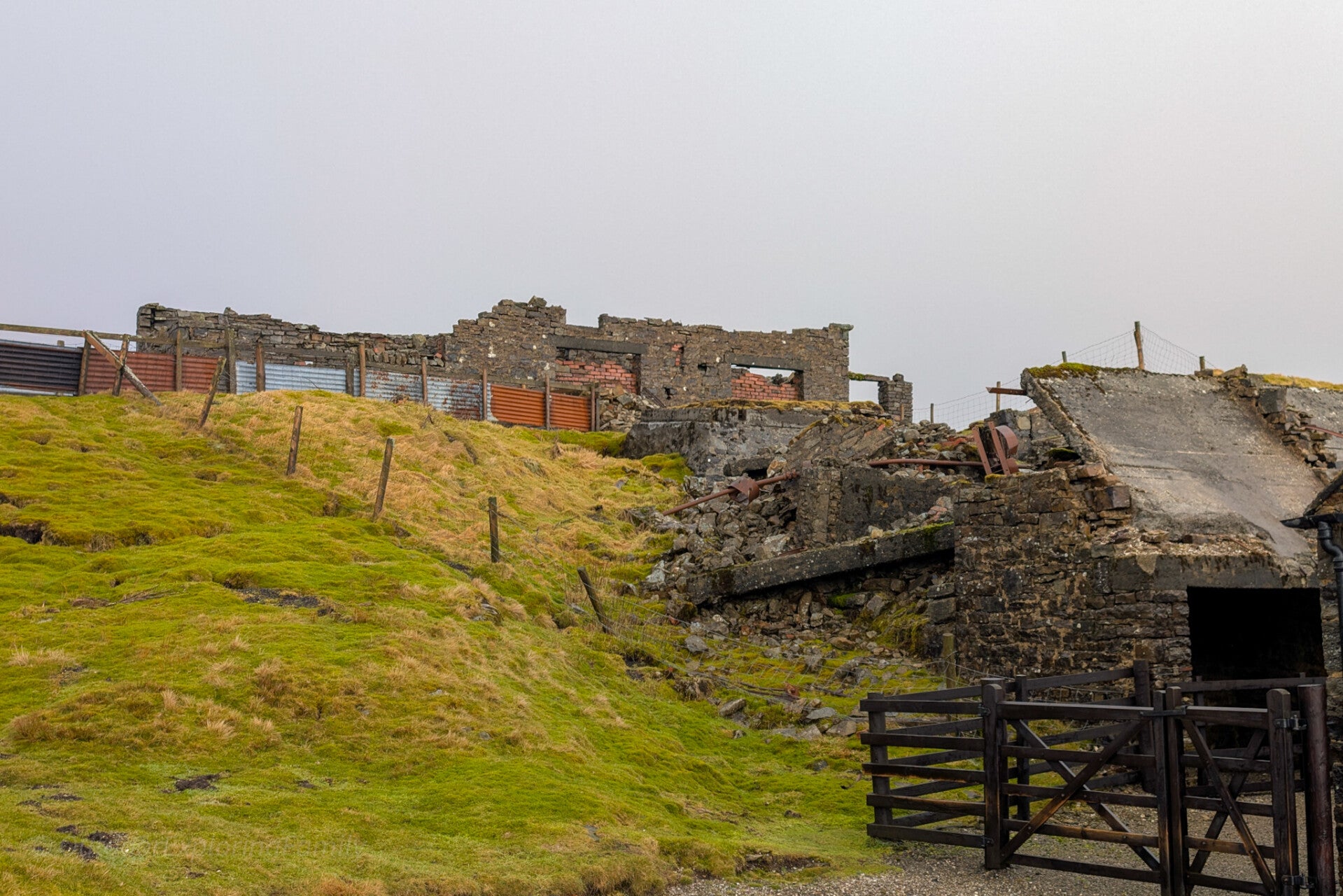 Old mine building at Dubbysike Mine near Cow Green in Upper Teesdale with stone walls, weathered doors and remote upland surroundings