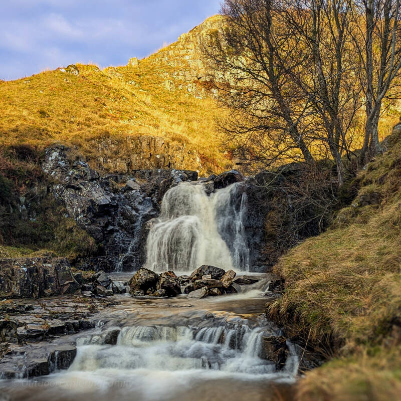 Flushiemere Waterfall in Teesdale surrounded by mossy rocks and natural landscape