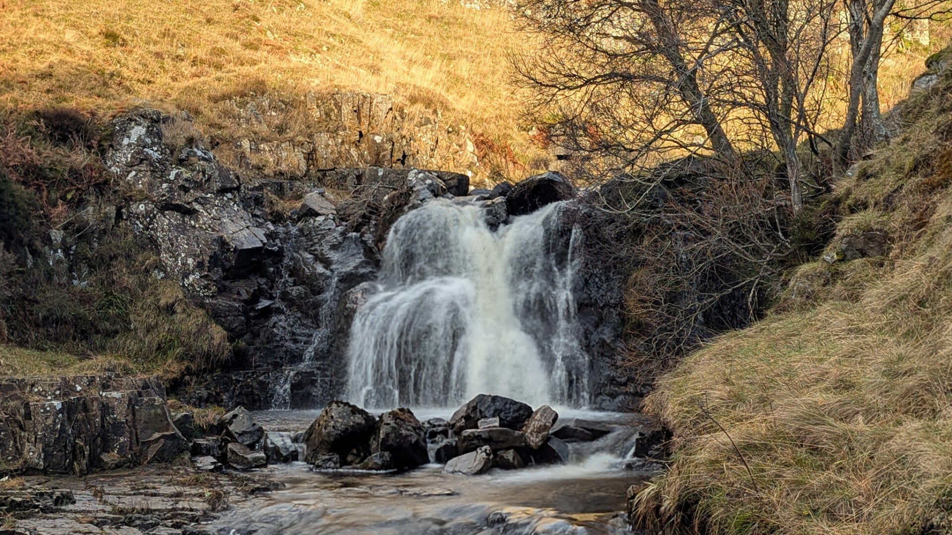Flushiemere Waterfall near Bowlees in Upper Teesdale with water flowing over layered rock