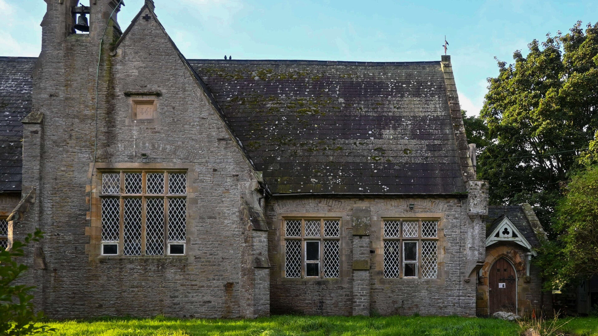Front of the 1861 London Lead Company School in Middleton-in-Teesdale showing the large school windows, bellcote and entrance