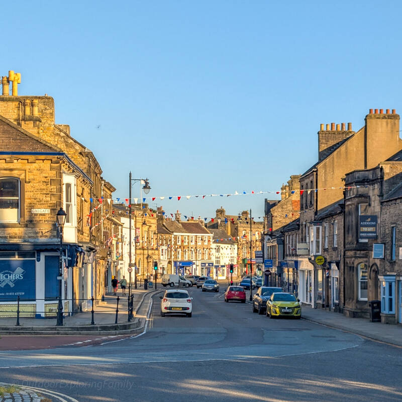 Galgate in Barnard Castle looking towards the town centre, with shops and stone buildings lining the broad street.