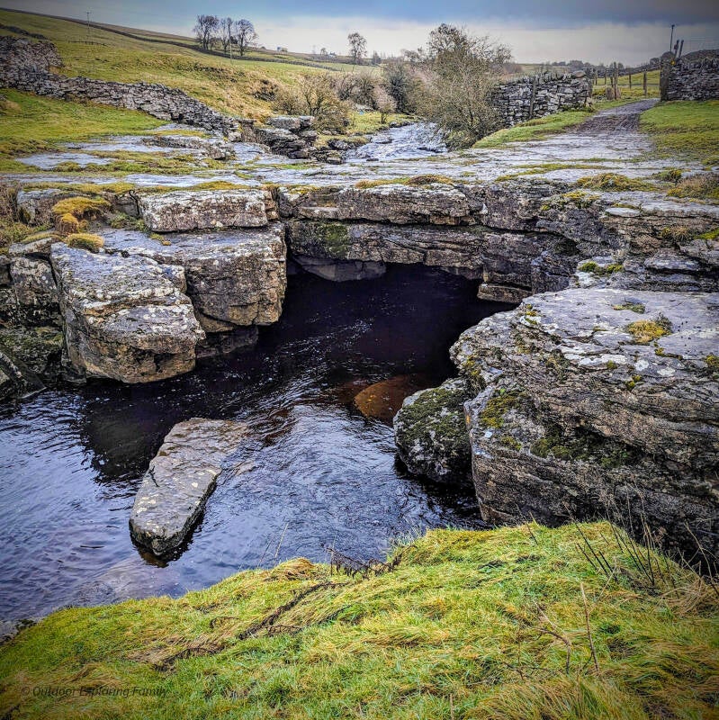 Natural limestone arch of God’s Bridge with the River Greta flowing beneath it in Teesdale.