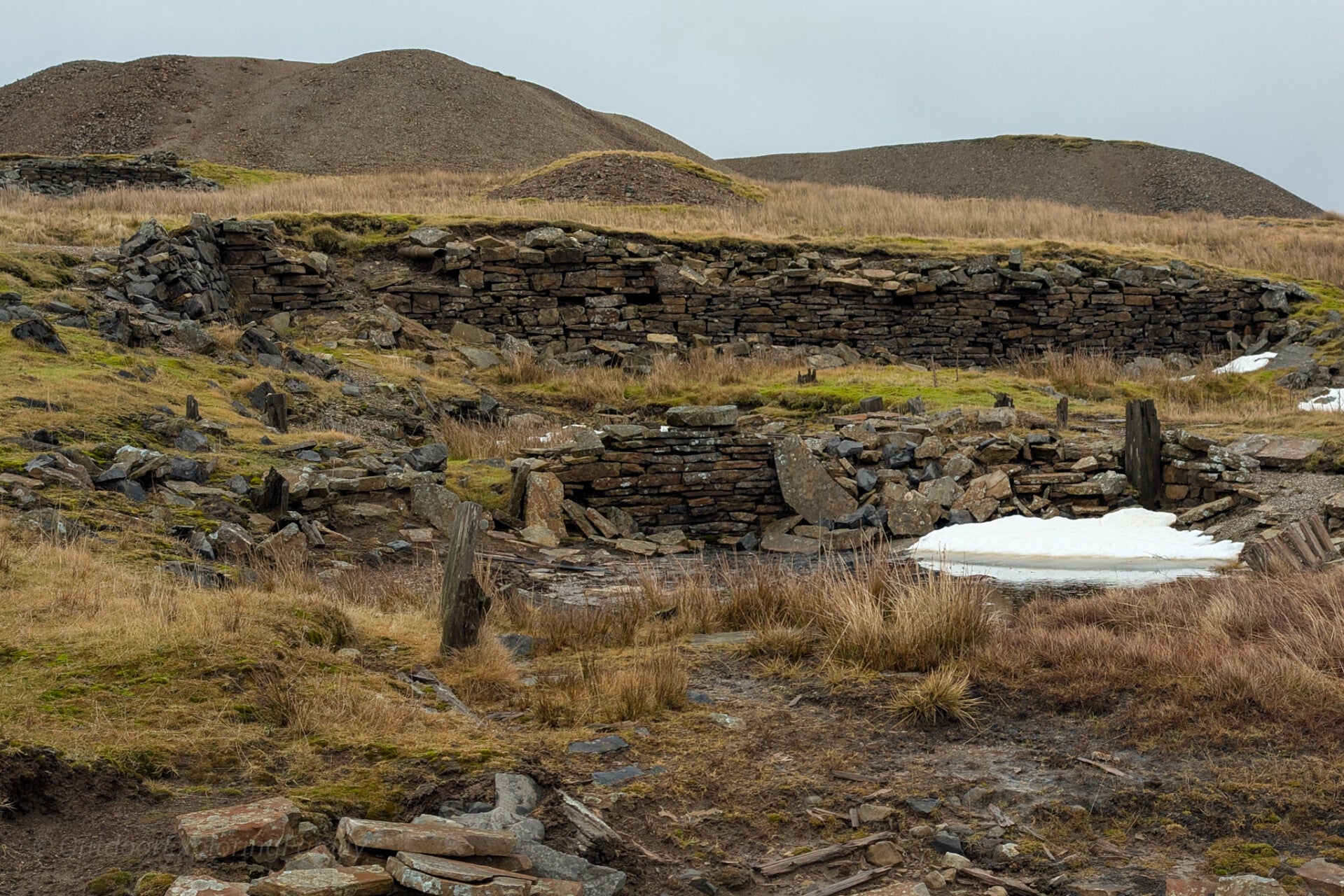 Ruins and workings at Greenhurth Mine near Cow Green in Upper Teesdale with collapsed stone structures and old industrial remains