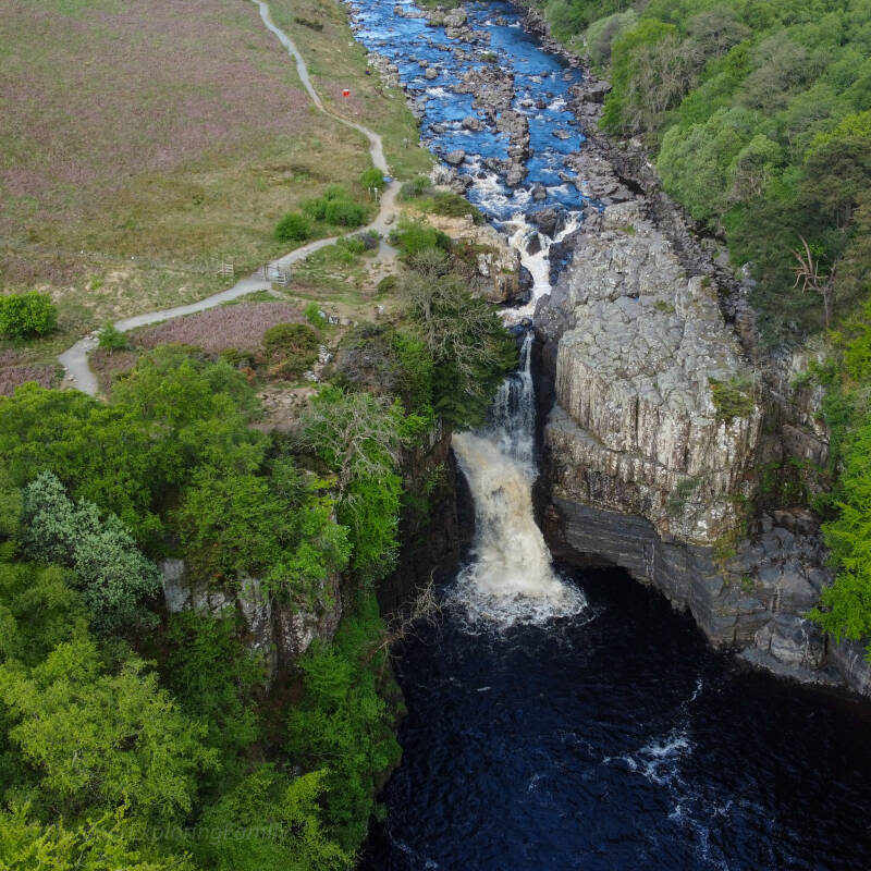 Drone view of High Force Waterfall and the River Tees gorge in Upper Teesdale showing the riverside walking path