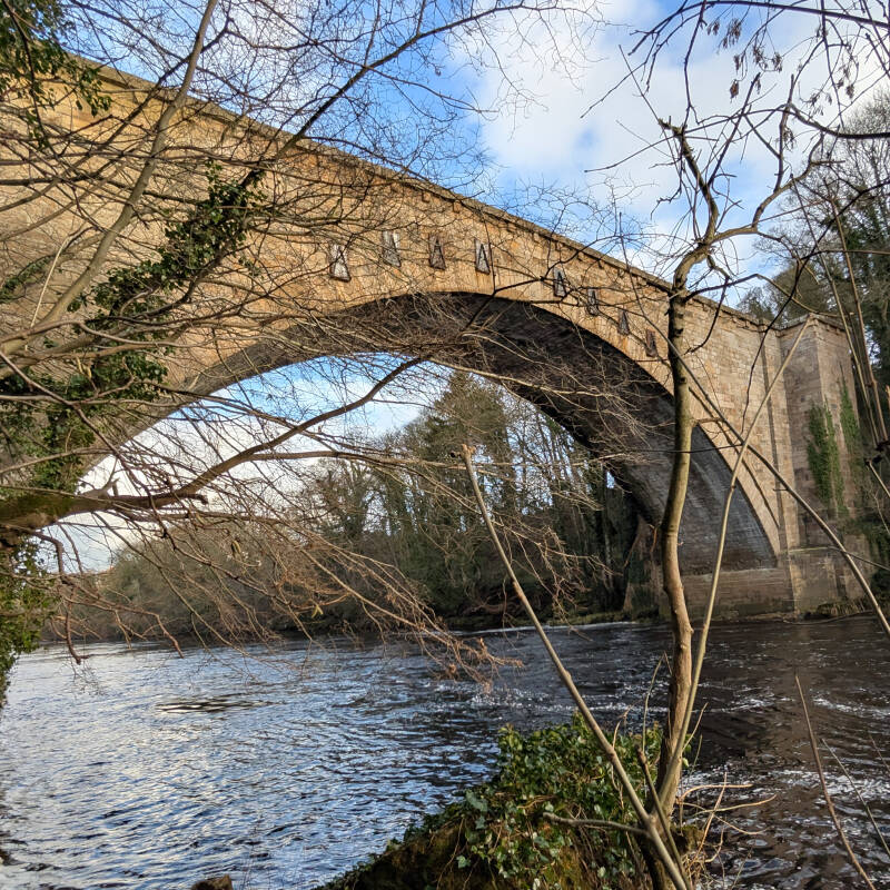 Winston Bridge crossing the River Tees near Barnard Castle in Teesdale, showing the huge Georgian stone arch above the wooded river valley