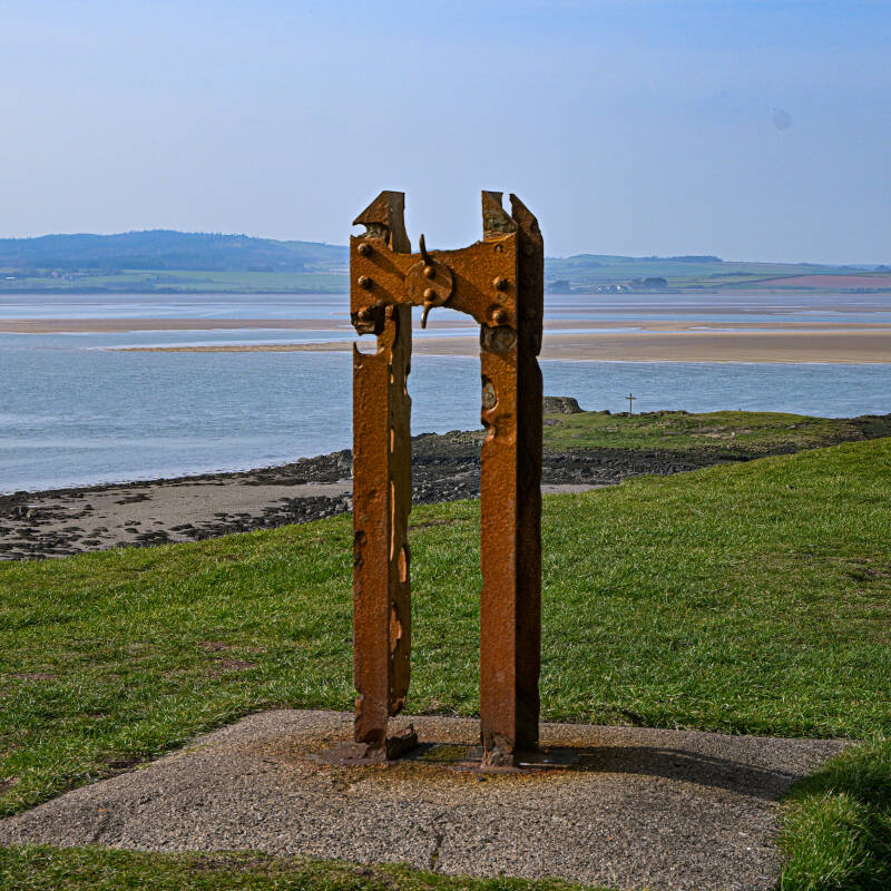 Rusted metal feature on the Heugh overlooking the sea and tidal flats around Holy Island