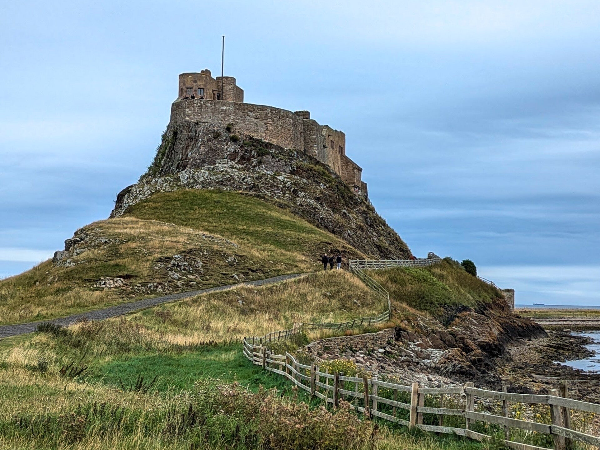 Lindisfarne Castle on its rocky outcrop above the shoreline on Holy Island, Northumberland