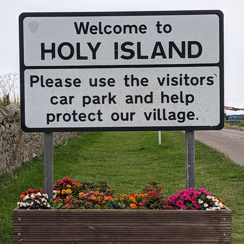 Welcome to Holy Island sign asking visitors to use the main visitor car park