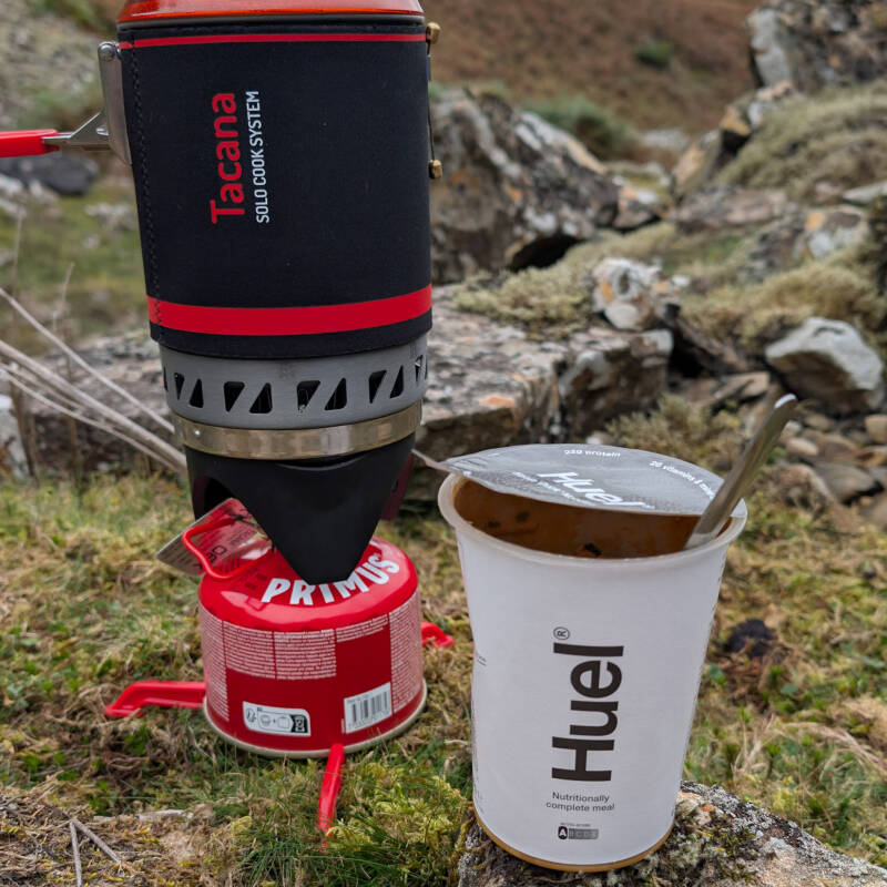 Camping stove boiling water outdoors for preparing a hot meal on a walk