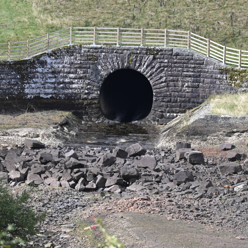 Large stone-lined opening exposed below the normal water level at Hury Reservoir during the 2026 drawdown