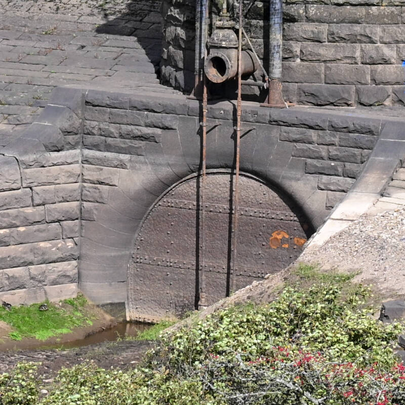 Large circular screened opening in the stonework at Hury Reservoir exposed by the low water in 2026