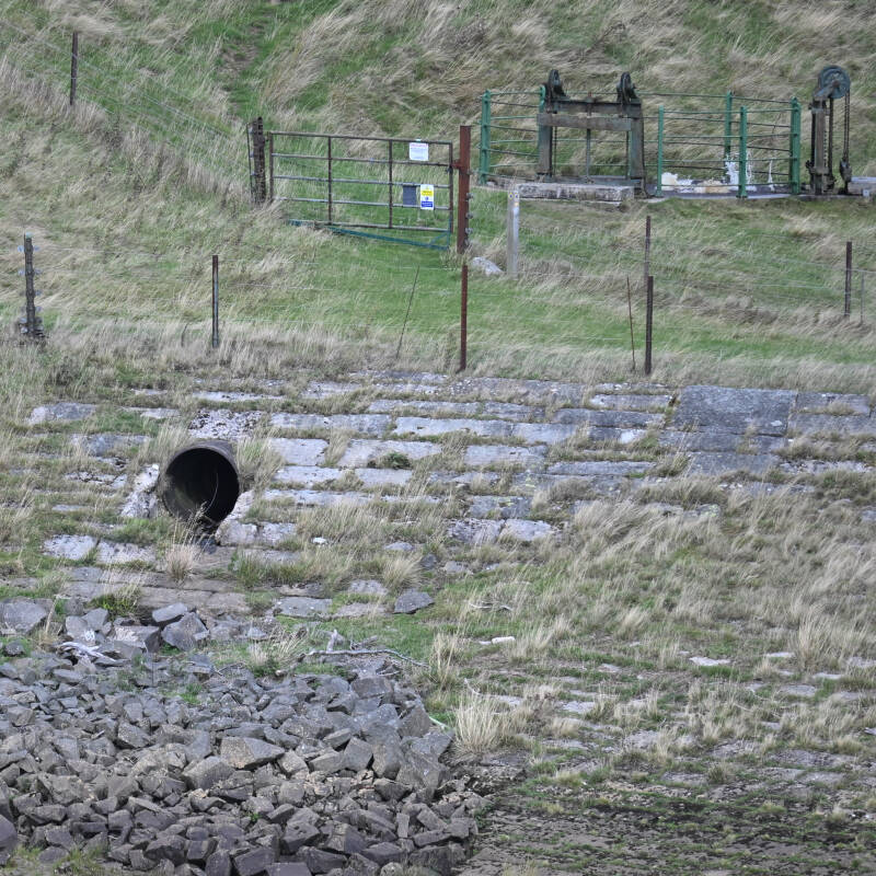 Pipe, stonework and reservoir equipment exposed above the lowered water level at Hury Reservoir during the 2026 drawdown
