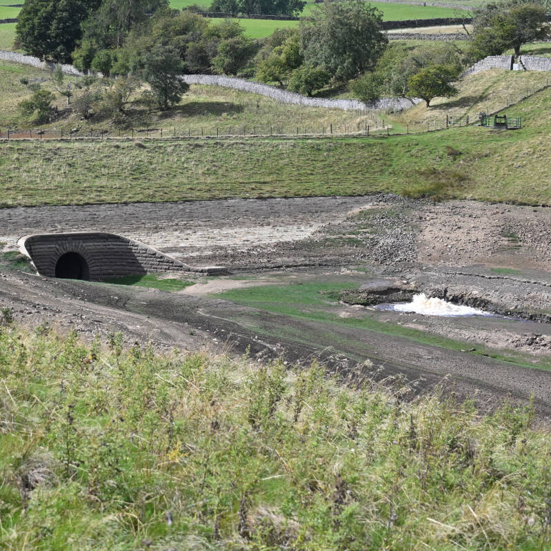 Stone arched opening and exposed reservoir bed at Hury Reservoir during the 2026 improvement works