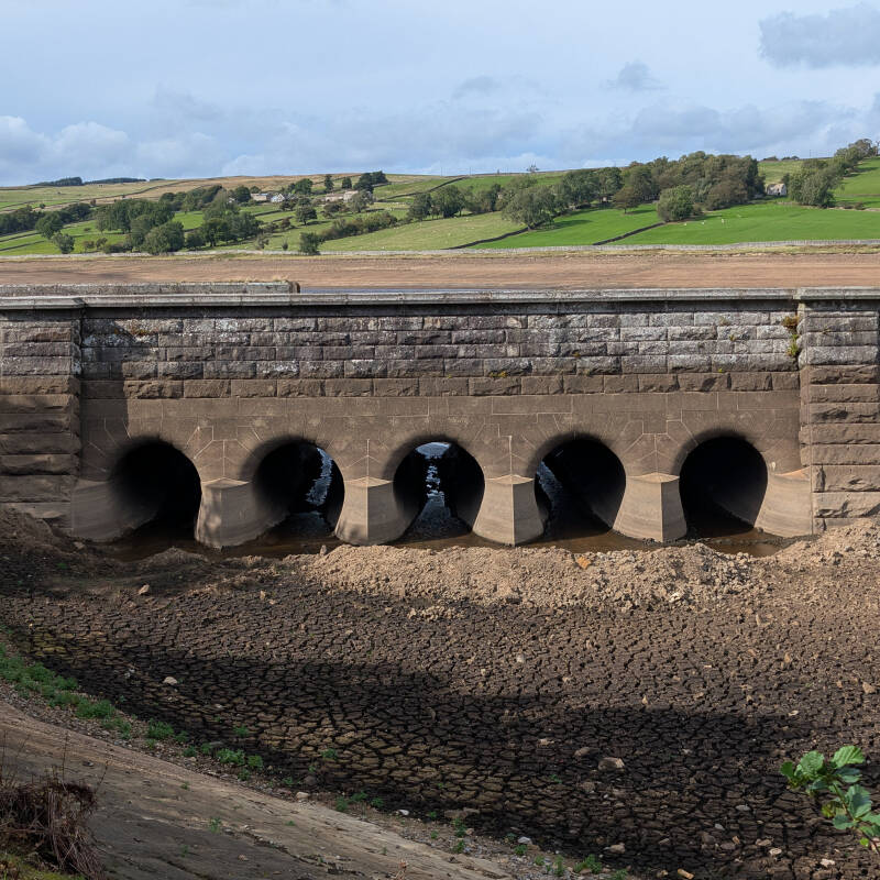 Five large stone openings exposed by the low water at Hury Reservoir during the 2026 drawdown