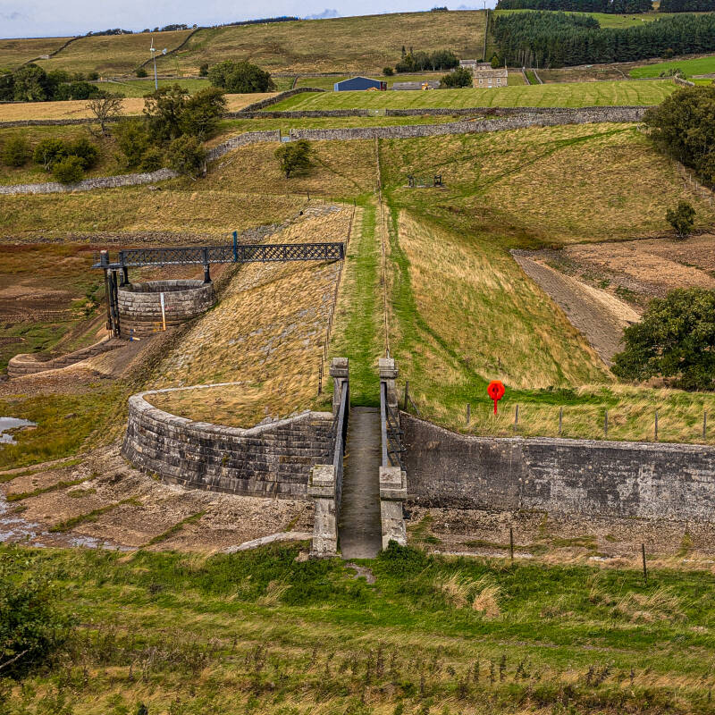 Stone waterworks structure and embankment exposed beside Hury Reservoir during the 2026 drawdown