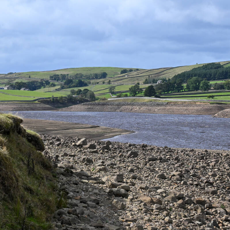 Rocky exposed shoreline and remaining water at Hury Reservoir in Baldersdale during the 2026 drawdown