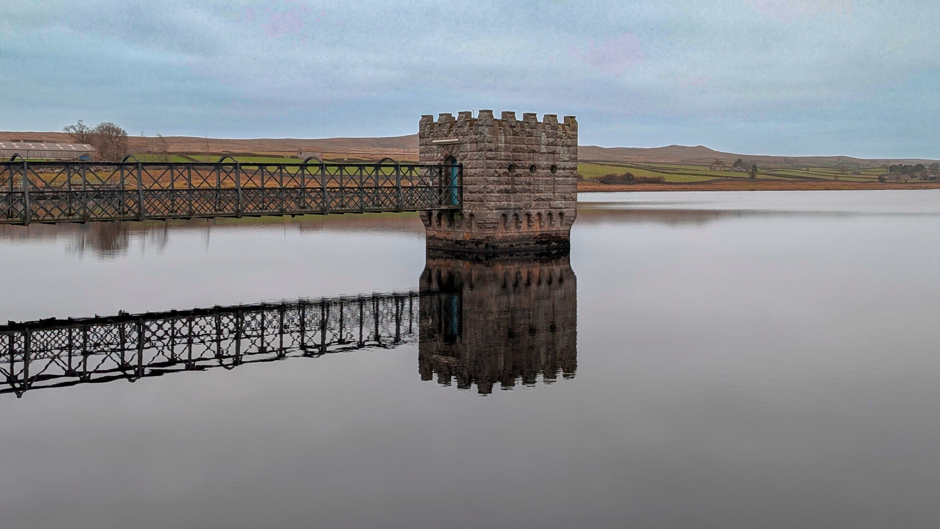 Victorian stone valve tower and iron footbridge at Hury Reservoir